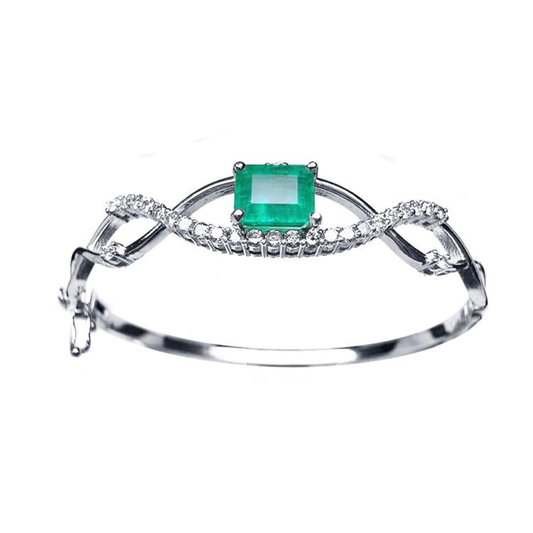 Colombian emerald bangle bracelet, emerald-cut 3.05 carats from the Muzo mines medium bluish green color.