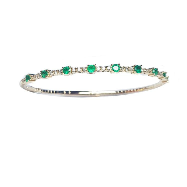 women's emerald bangle bracelet flexible made in 14k yellow gold and genuine Colombian emeralds.