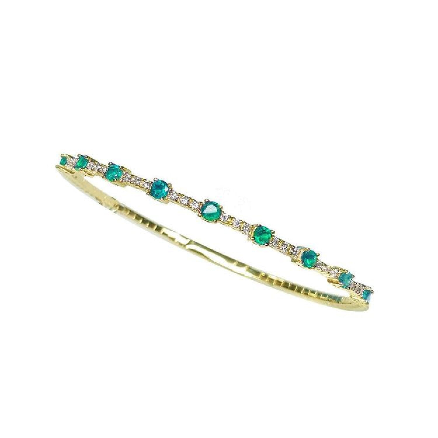 Flexible 14K yellow gold bangle bracelet with round emeralds and accent diamonds.
