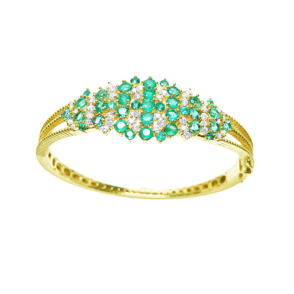 Gold bangle bracelet with emeralds and diamonds on a white background