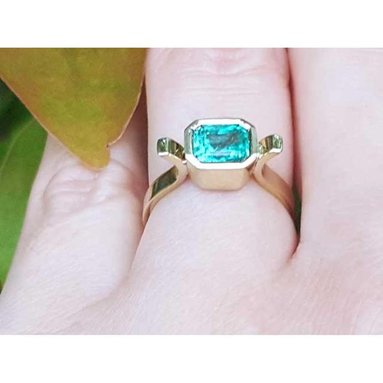A yellow gold colombian emerald ring bezel set crafted in solid 14k yellow gold.