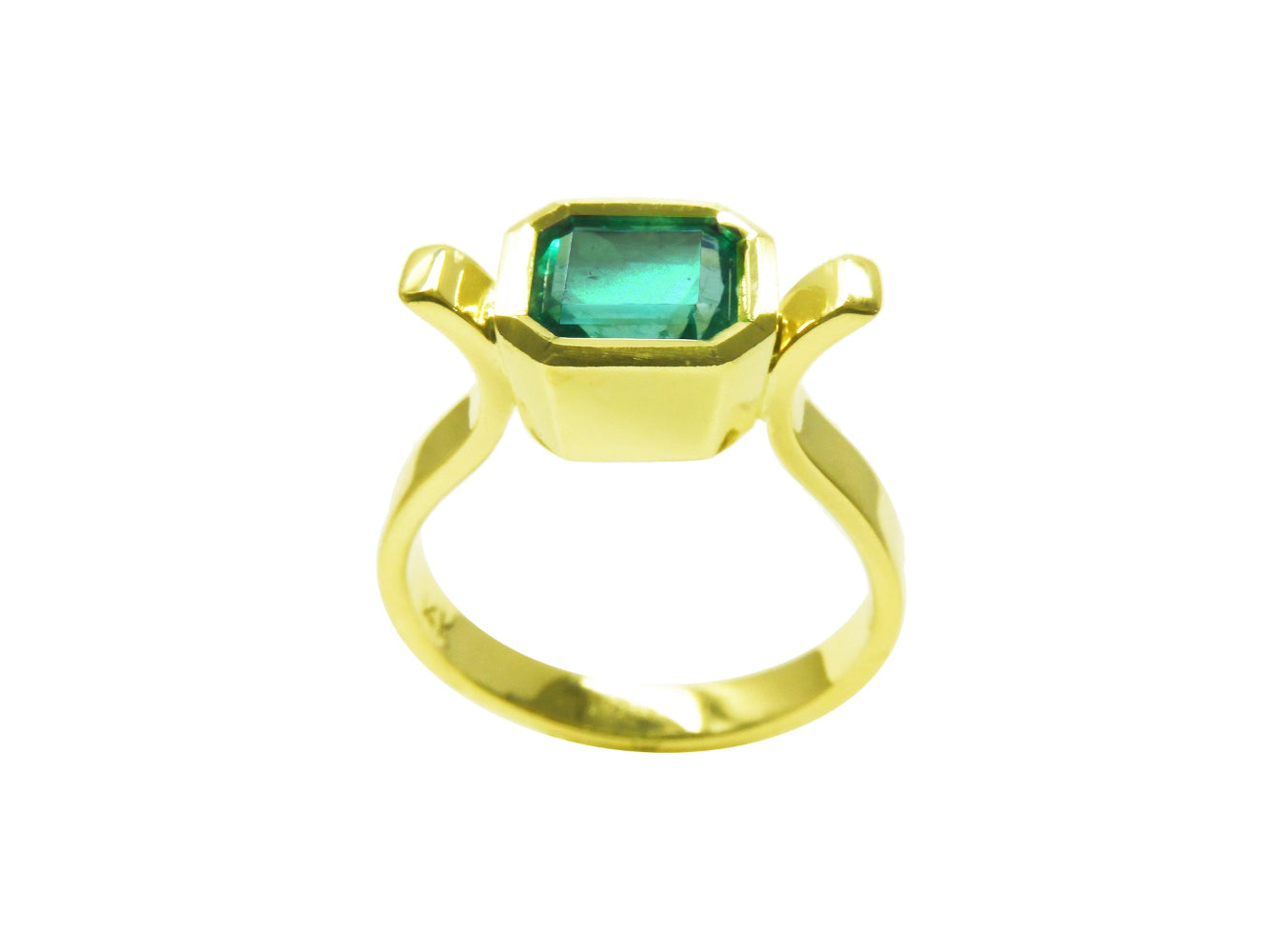 this yellow gold emerald solitaire ring displays the top side profile.