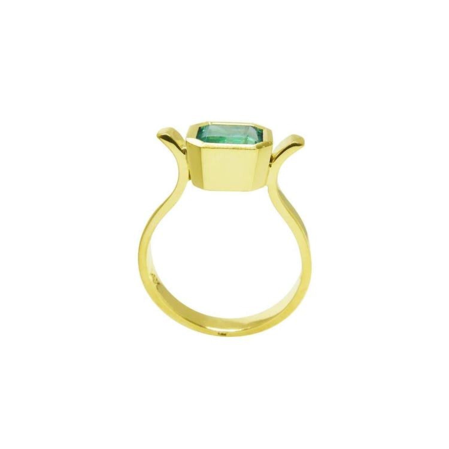 0.93 ct. solitaire Colombian emerald ring in 14K yellow gold, featuring a bezel-set emerald cut stone.