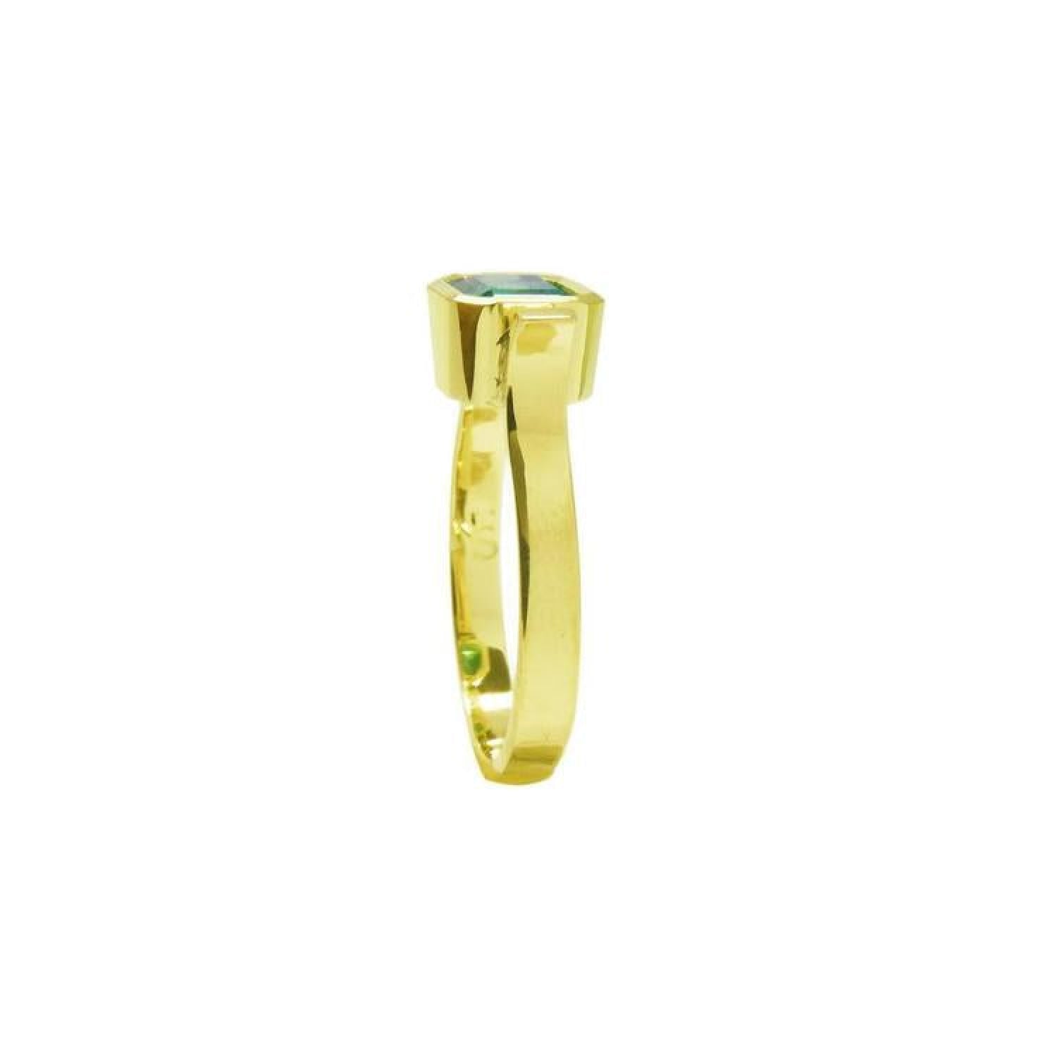 0.93 ct. solitaire Colombian emerald ring in 14K yellow gold with a bezel setting.
