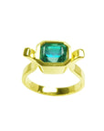 A  colombian emerald solitaire ring bezel set made of 14k yellow gold.