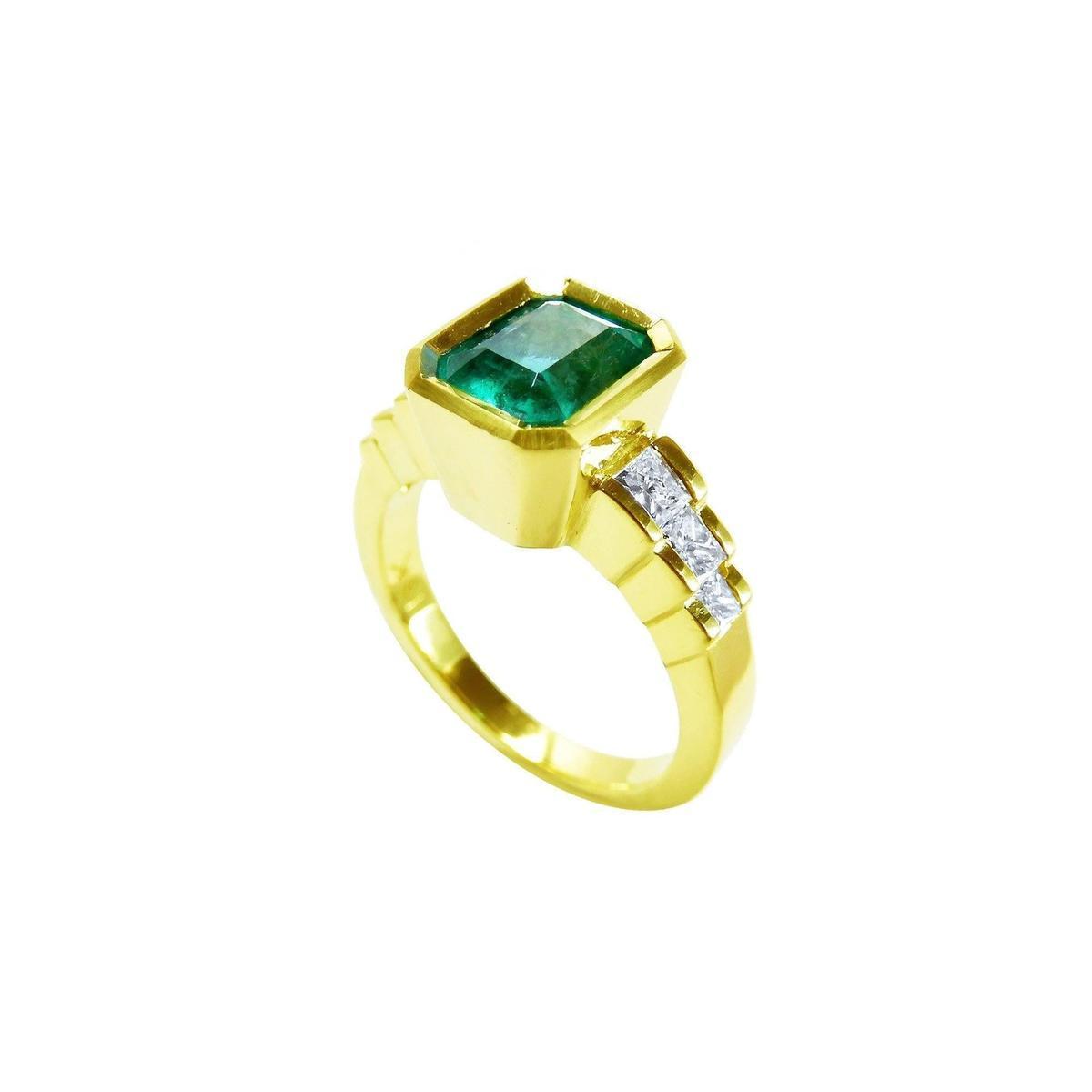 An emerald-cut bezel set emerald ring for women, on top and side view profile position.