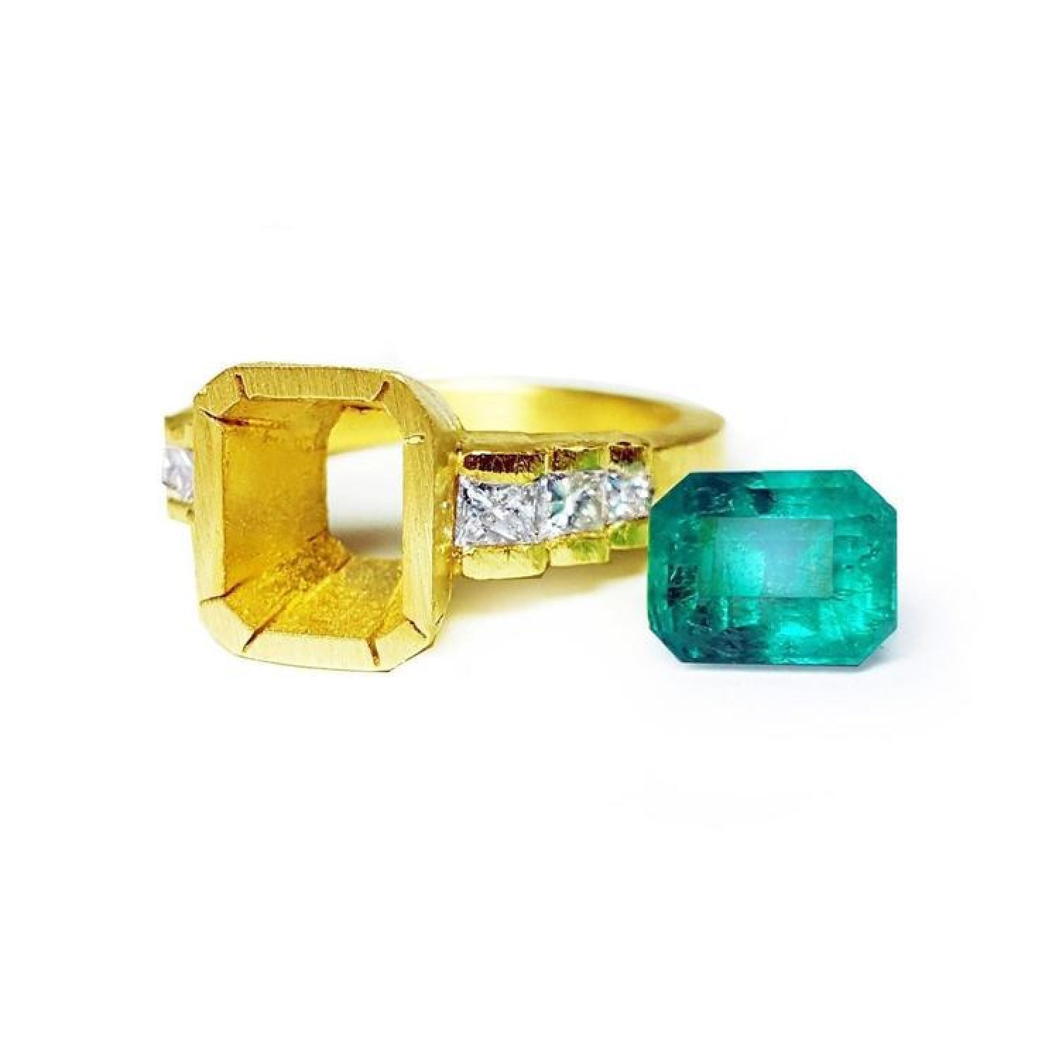 18K gold ring setting with bezel-set princess cut diamonds, beside a loose emerald-cut bluish-green emerald.