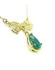 18K yellow gold bow-tie necklace with pave yellow diamonds and a dangling pear-shaped emerald.