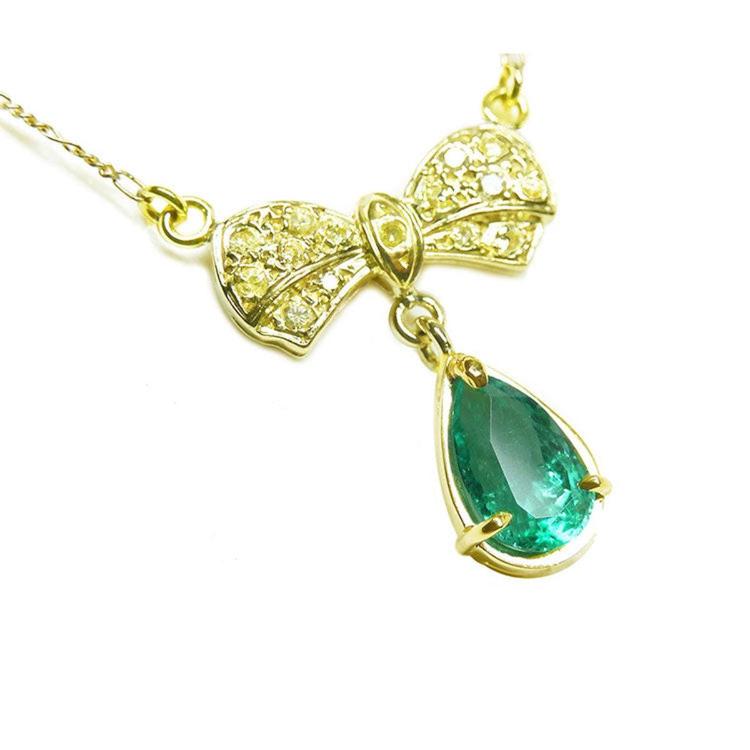 Emerald bowtie necklace natural from Muzo mine in Colombia pear cut, yellow diamonds pave set in 18k yellow gold