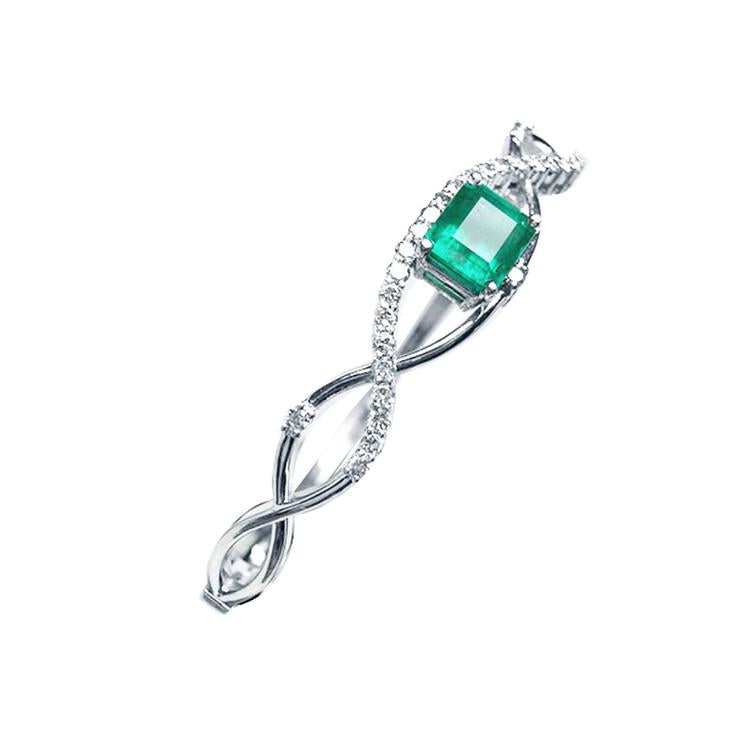 14K white gold bangle bracelet with a central emerald-cut green emerald and entwined diamond strips.