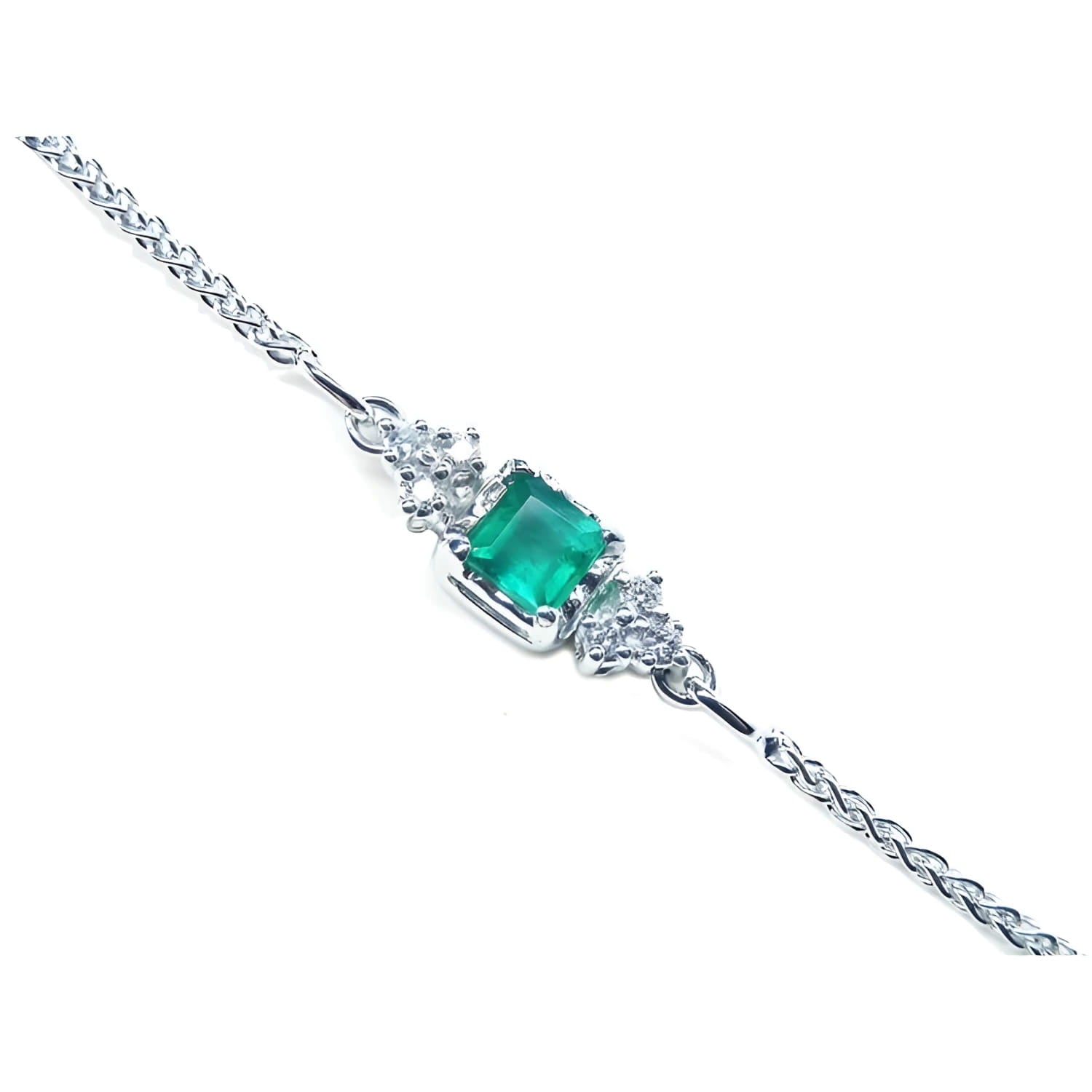 14K white gold bracelet with a central emerald-cut Colombian emerald and diamond accents.