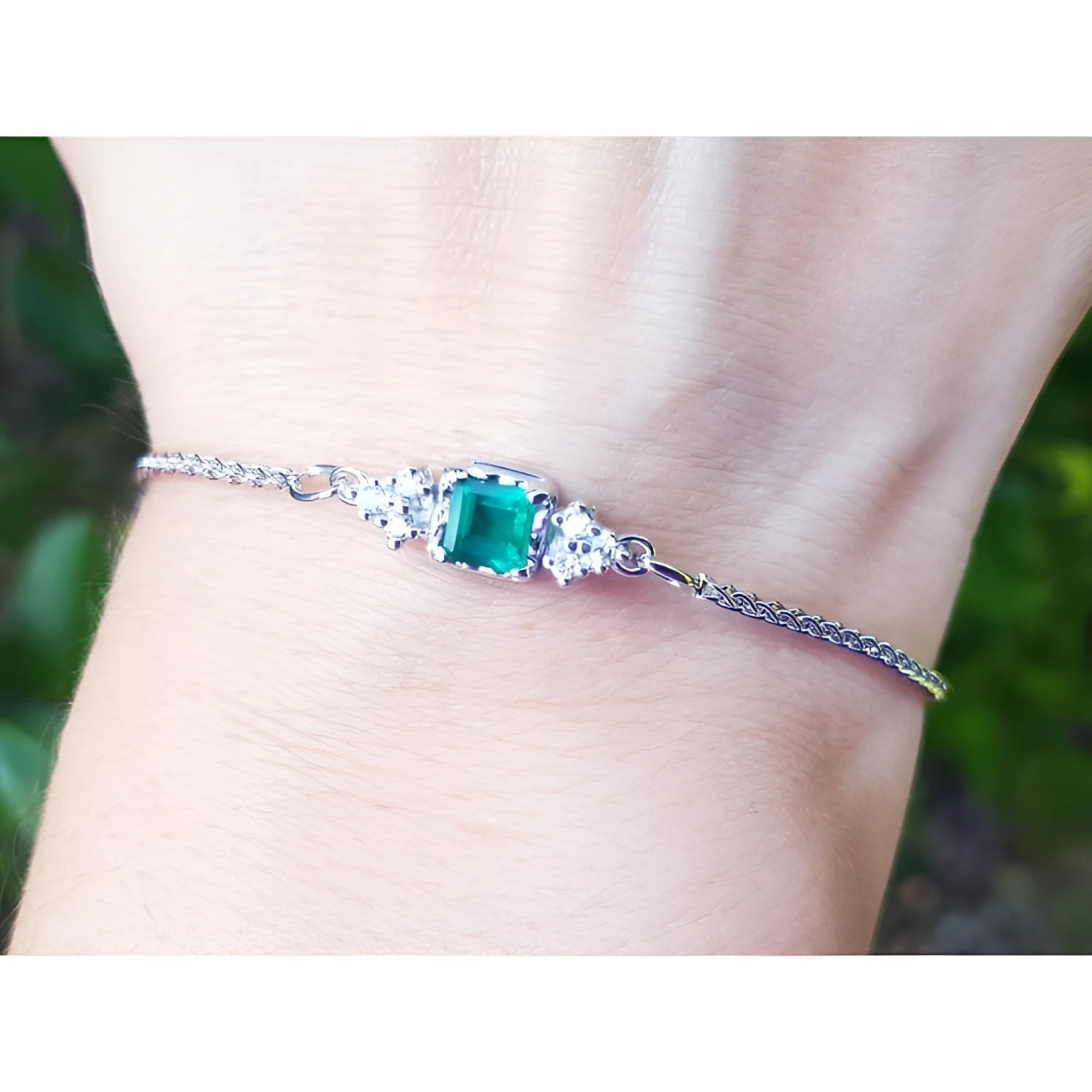A square emerald-cut bracelet Colombian emerald with accent diamond in 14k white gold.