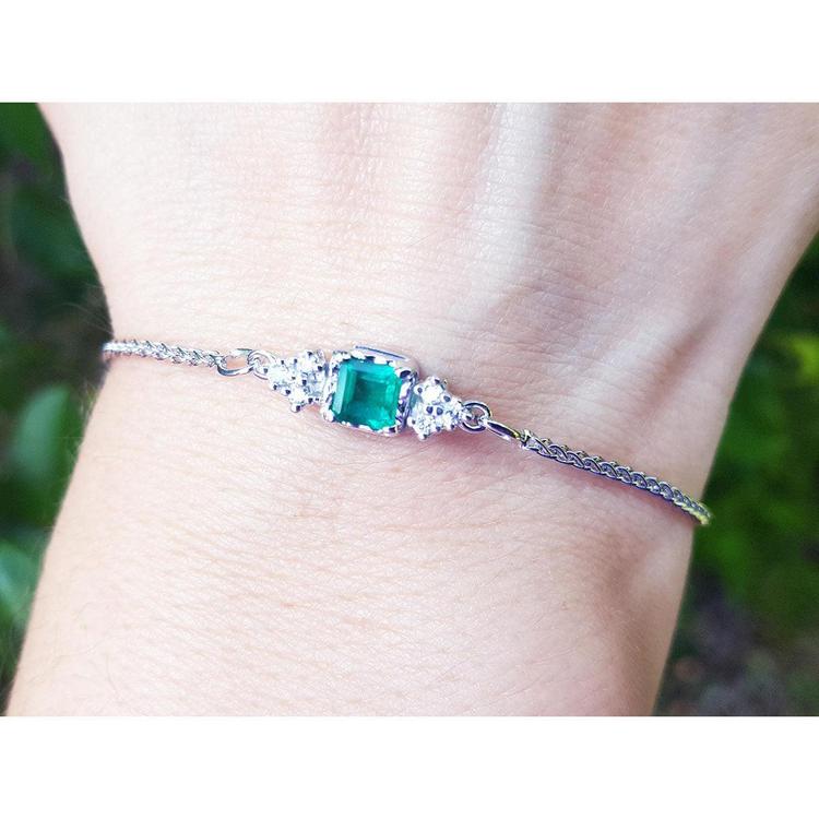 A square emerald-cut bracelet Colombian emerald with accent diamond in 14k white gold.