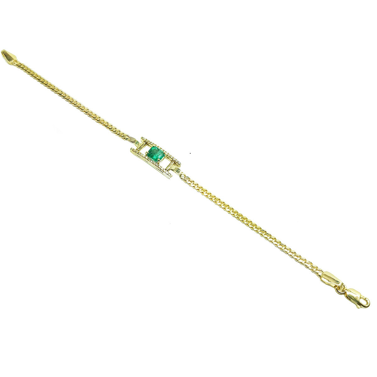 A distan view of a yellow gold bracelet with a Muzo emerald on a topside position.