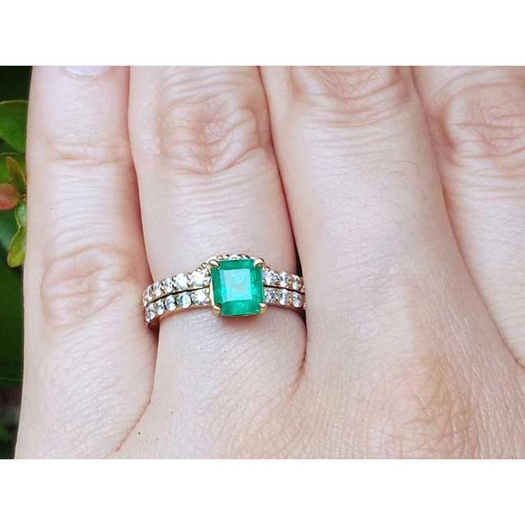 A natural emerald bridal ring with diamond matching band set in 14k gold.