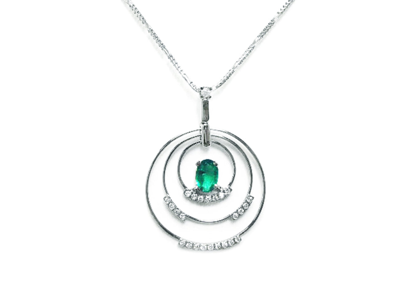 A distant view of a triple circle of life natural colombian emerald pendant made in 14k white gold.