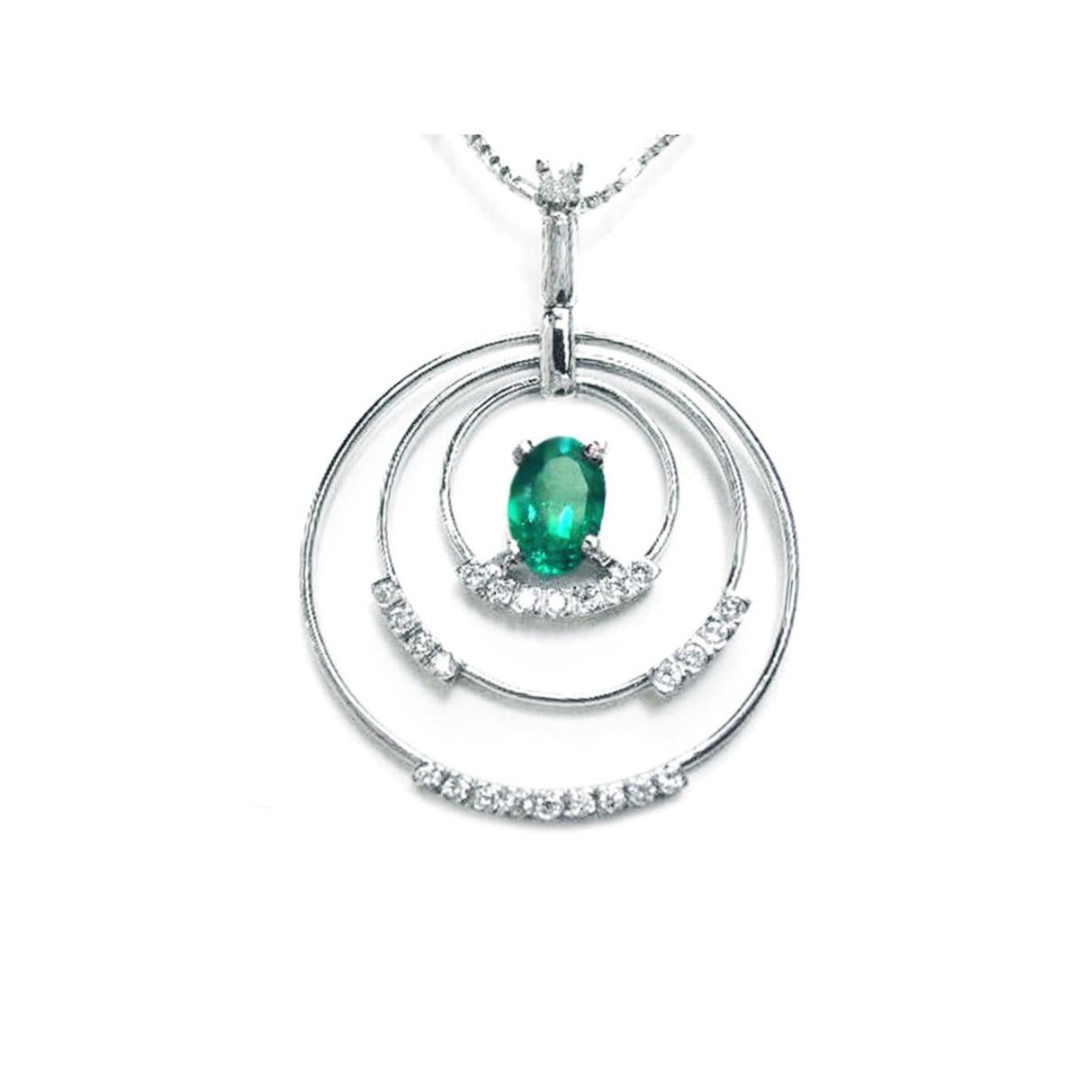 A frontside view of a triple circle of life pendant adorned with natural diamonds, in the center an oval cut colombian emerald.