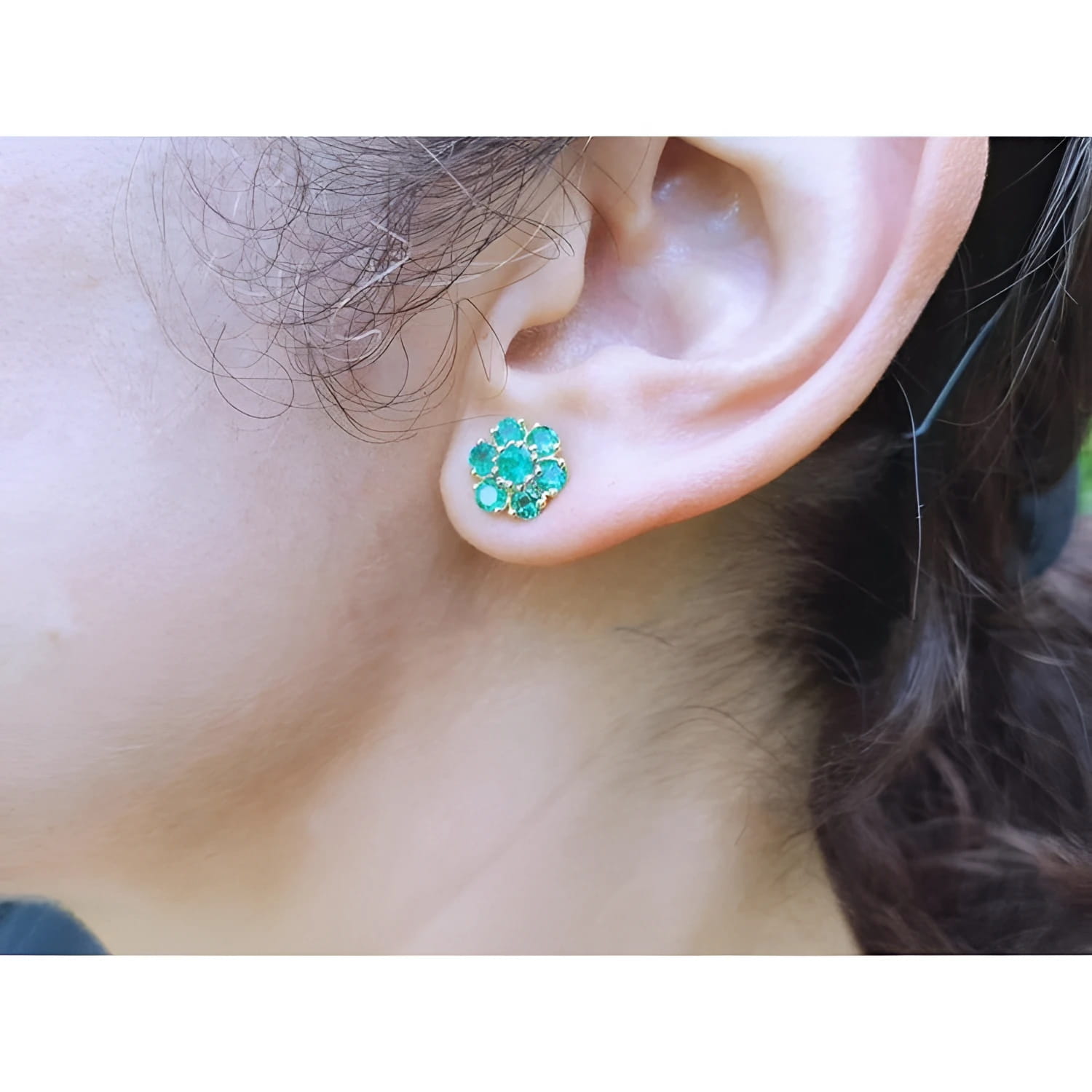 Colombian emerald cluster earrings with six round-cut petals, vibrant medium green, 18K yellow gold stud.