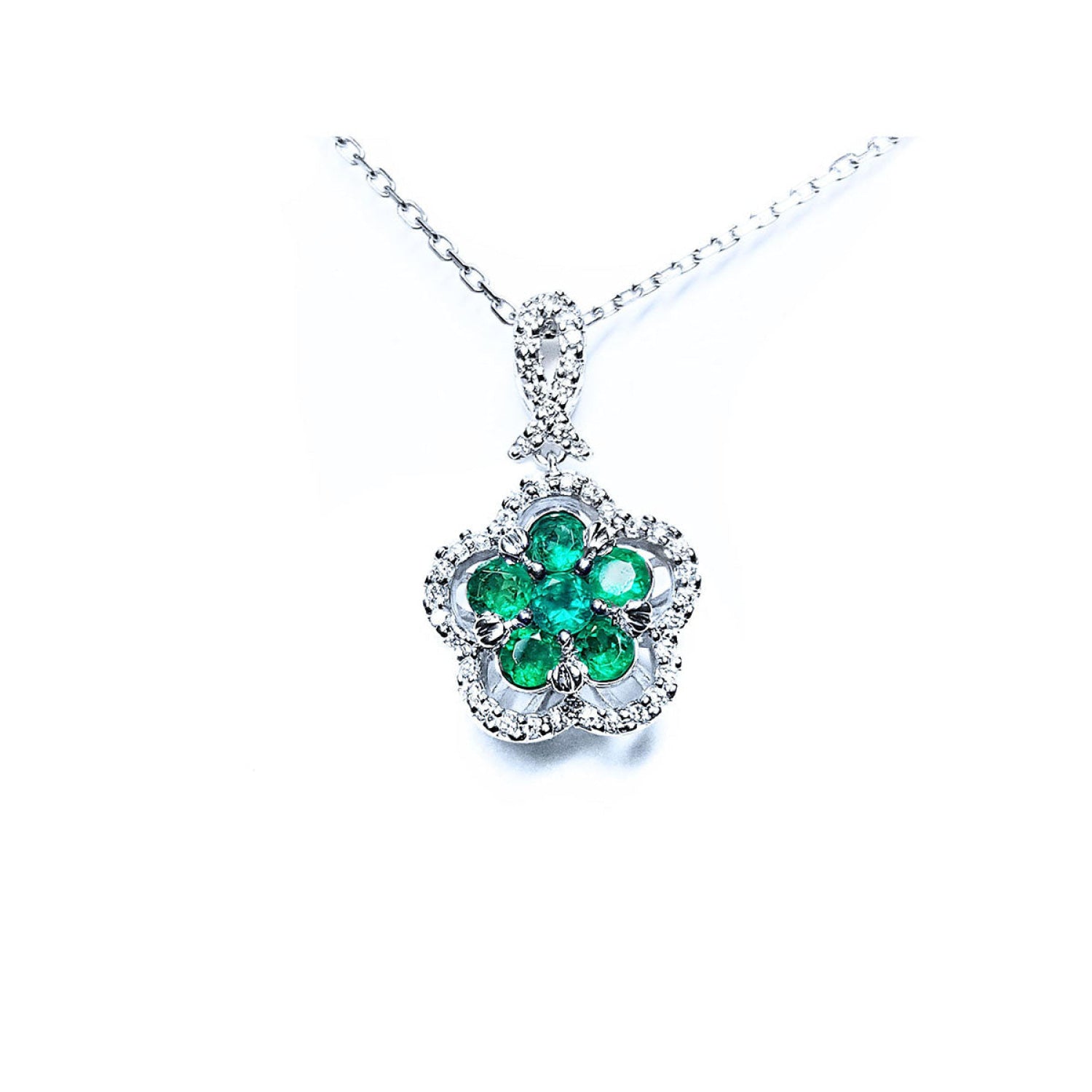 14K white gold emerald cluster necklace with five petals, surrounded by diamonds.