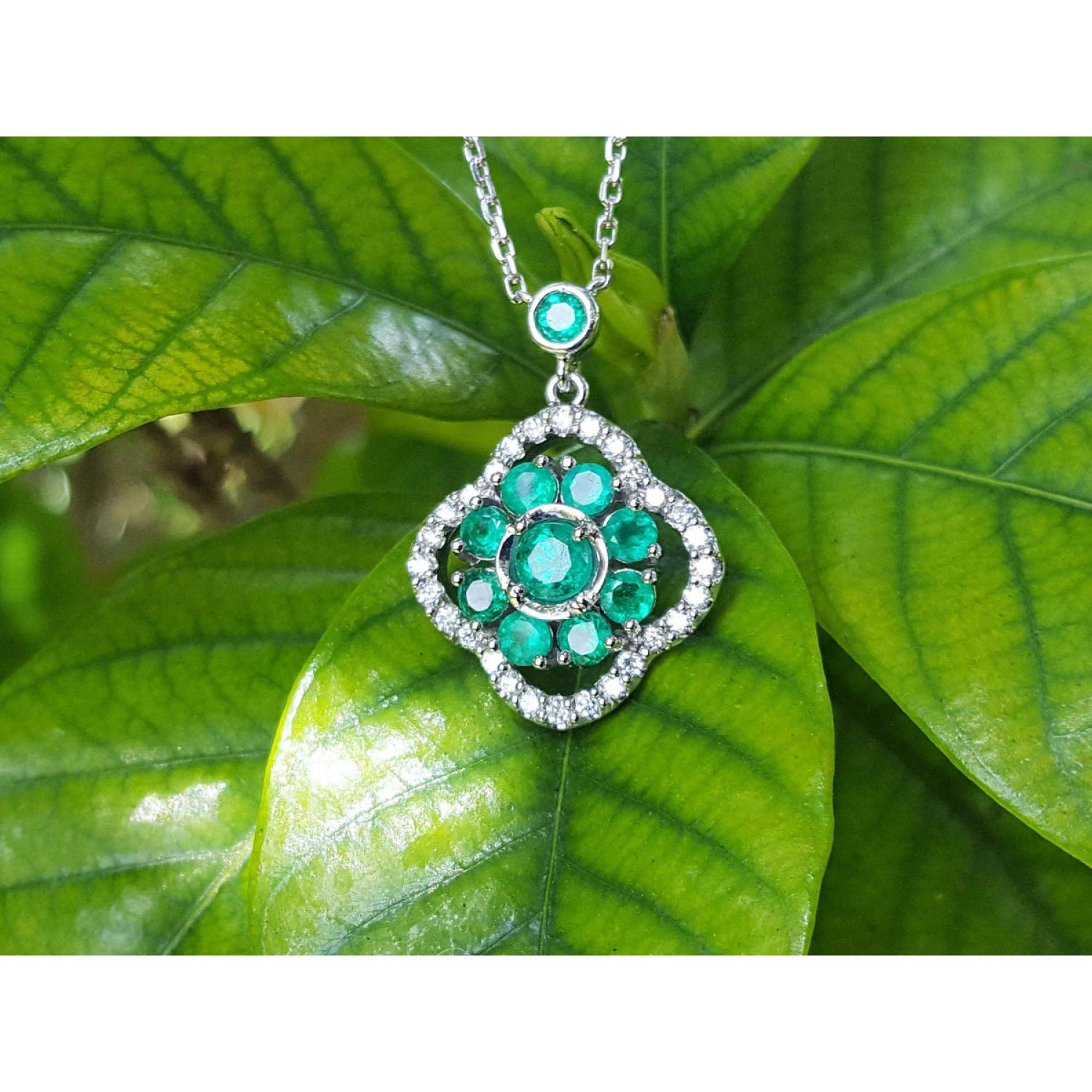14K white gold cluster necklace with natural Colombian emeralds and diamond 4-leaf clover design.