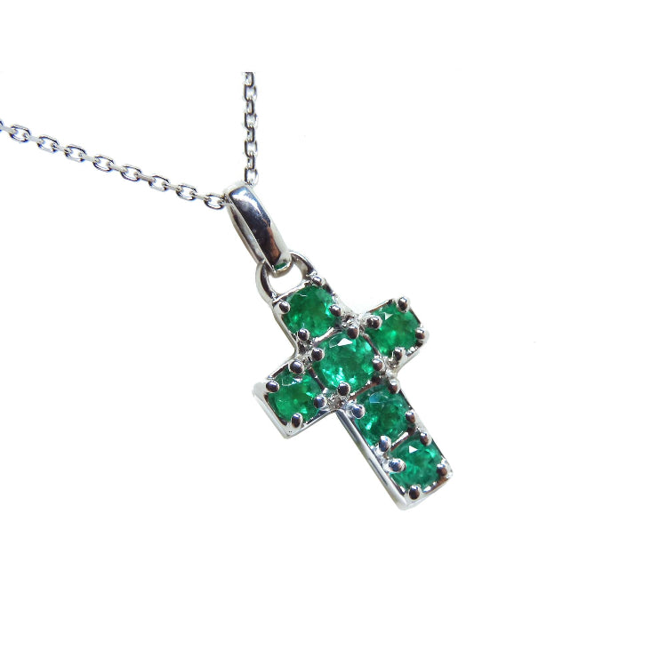 Cross-shaped natural colombian emerald pendant on chain made of 14k white gold.
