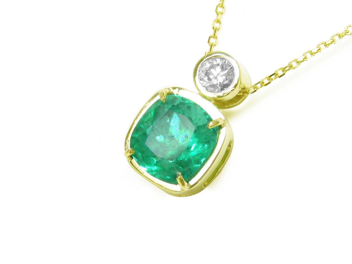 This 18k yellow gold cushion cut emerald pendant necklace displays the topside and galley perspective.