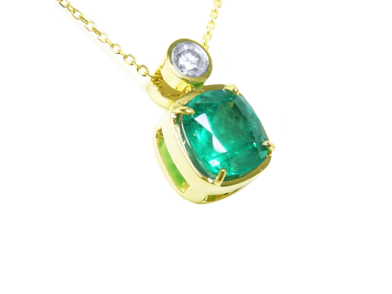 Right side profile of a cushion cut emerald pendant necklace, top and gallery view.