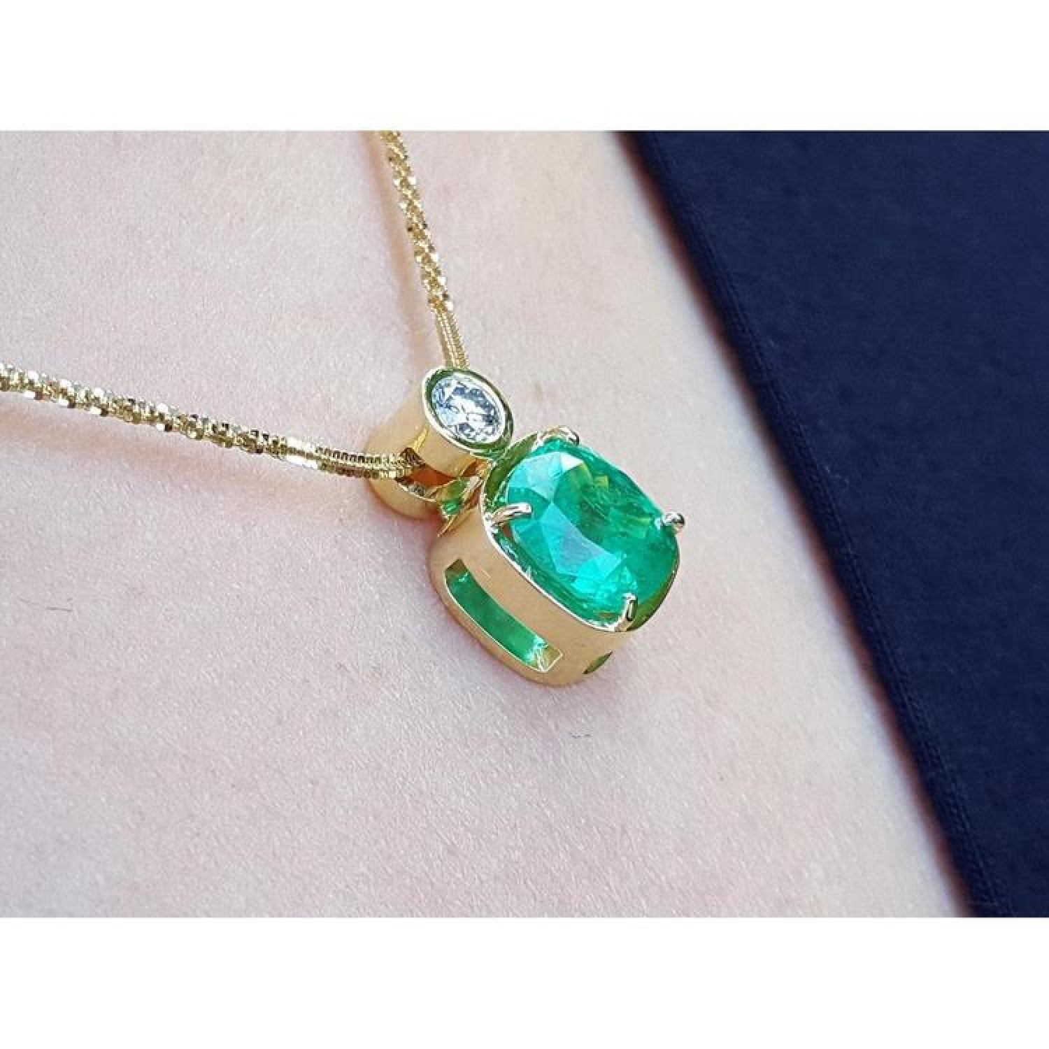 3.43 ct. emerald cushion cut pendant in 18K yellow gold with a brilliant diamond accent.
