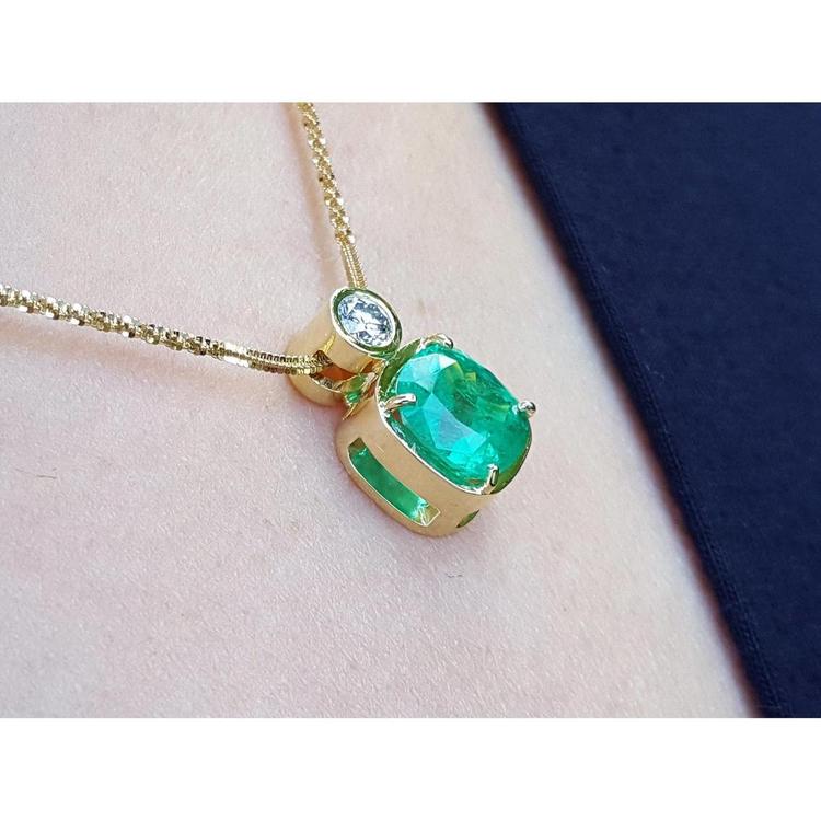 3.43 ct. emerald cushion cut pendant in 18K yellow gold with a brilliant diamond accent.