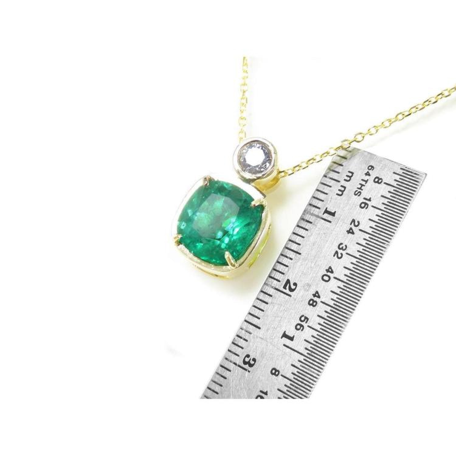 3.43 ct. deep bluish-green emerald cushion cut pendant in 18K yellow gold with a small diamond accent.