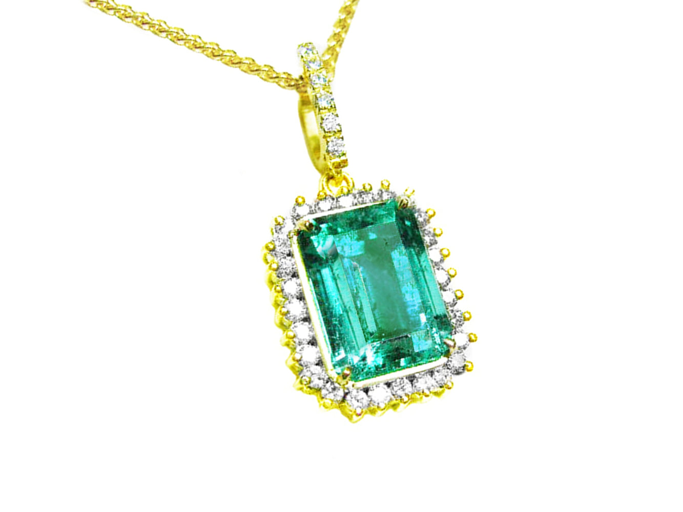 
the topside view of a natural colombian emerald pendant emerald-cut surrounded by a halo diamond in 18k yellow gold.