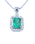 Emerald pendant with diamond accents on a white background