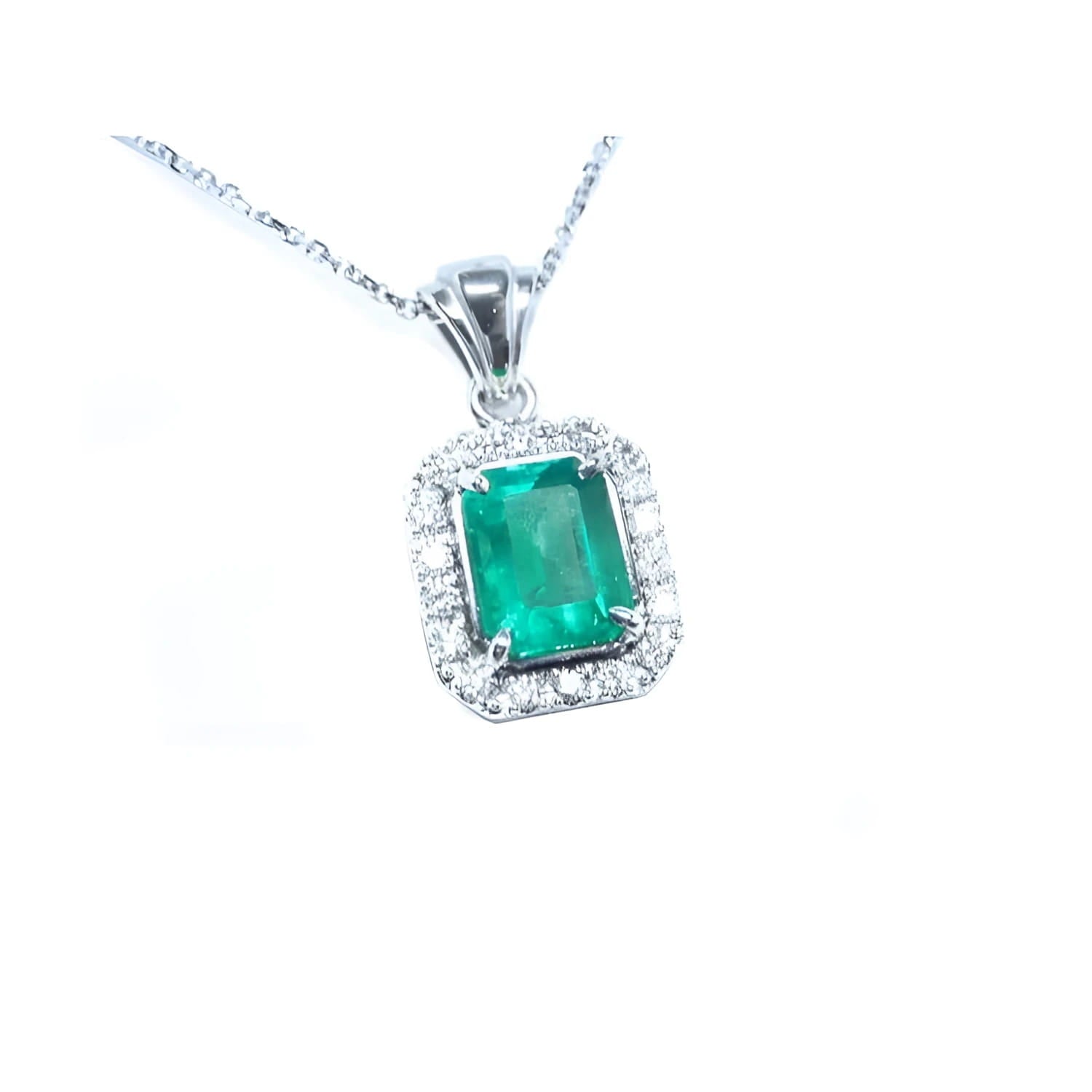 Emerald-cut emerald pendant with halo diamonds in 14K white gold on a delicate chain.