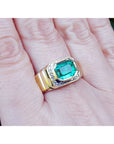 Gold ring for man with a rectangular natural Muzo mine emerald on a hand.