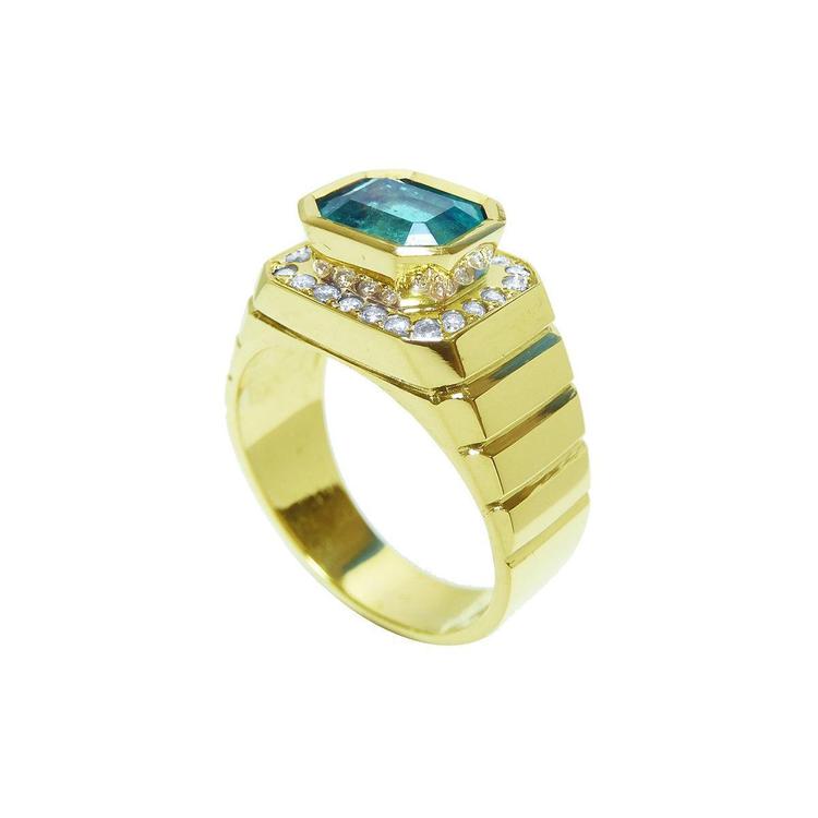 Gold ring for man with a genuine colombian emerald and diamond accents on a half side position.