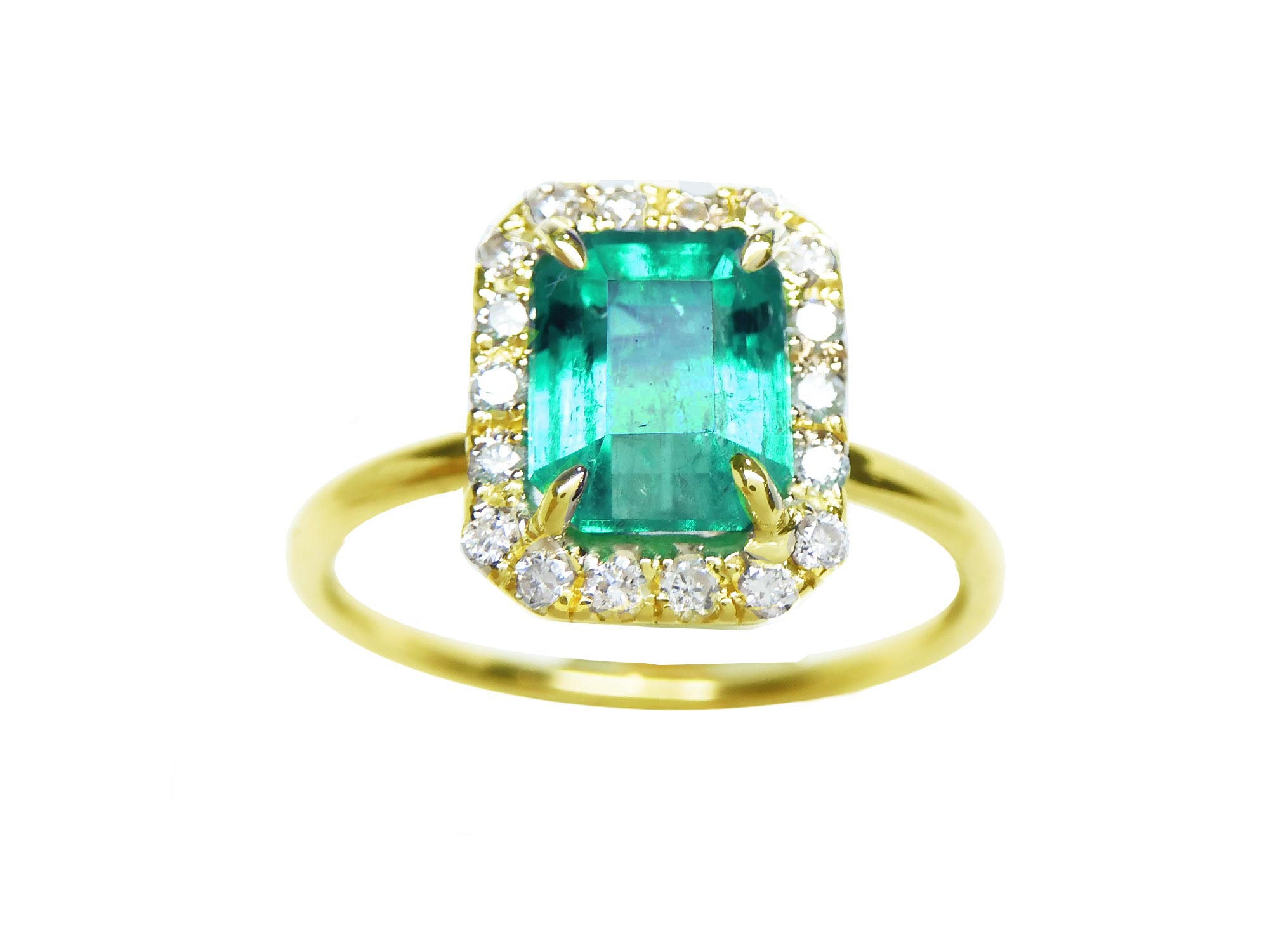 A rectangular emerald encircled into a halo diamond ring topside view.