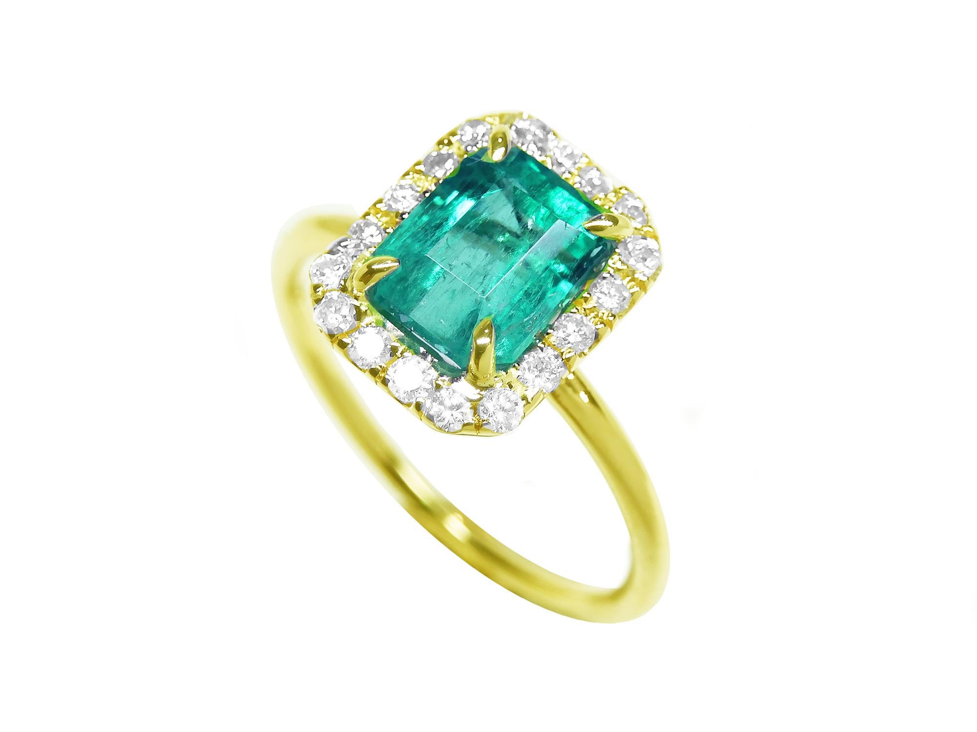 This emerald ring on a tilted position is displaying the top emerald, halo diamond and band of the ring.