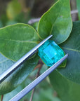 Emerald-cut 2.76 ct. Muzo mine loose emerald front side table and crown on top three leaves