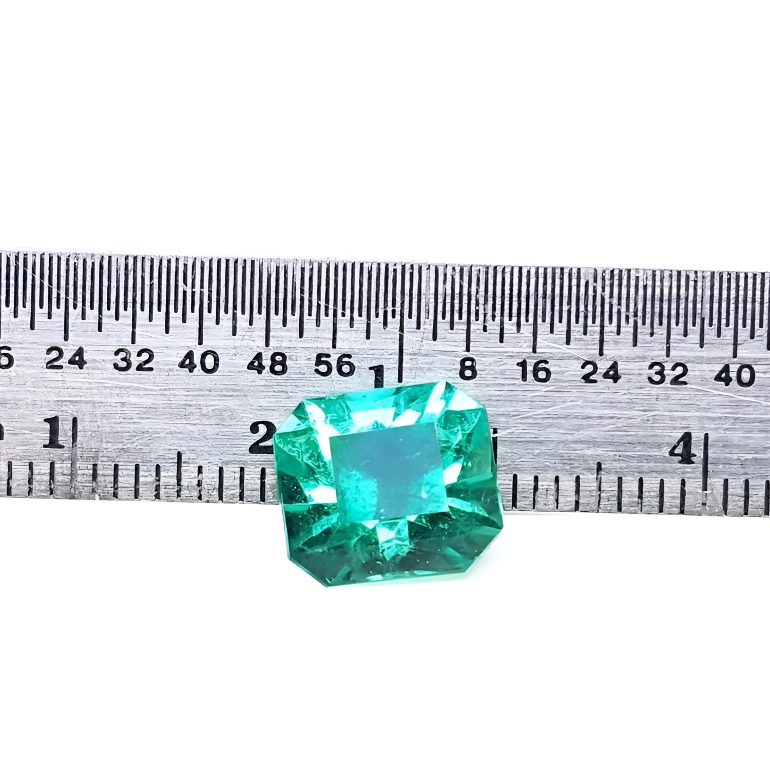 3.60 ct GIA certified loose Colombian emerald, medium bluish green, shown with a ruler.