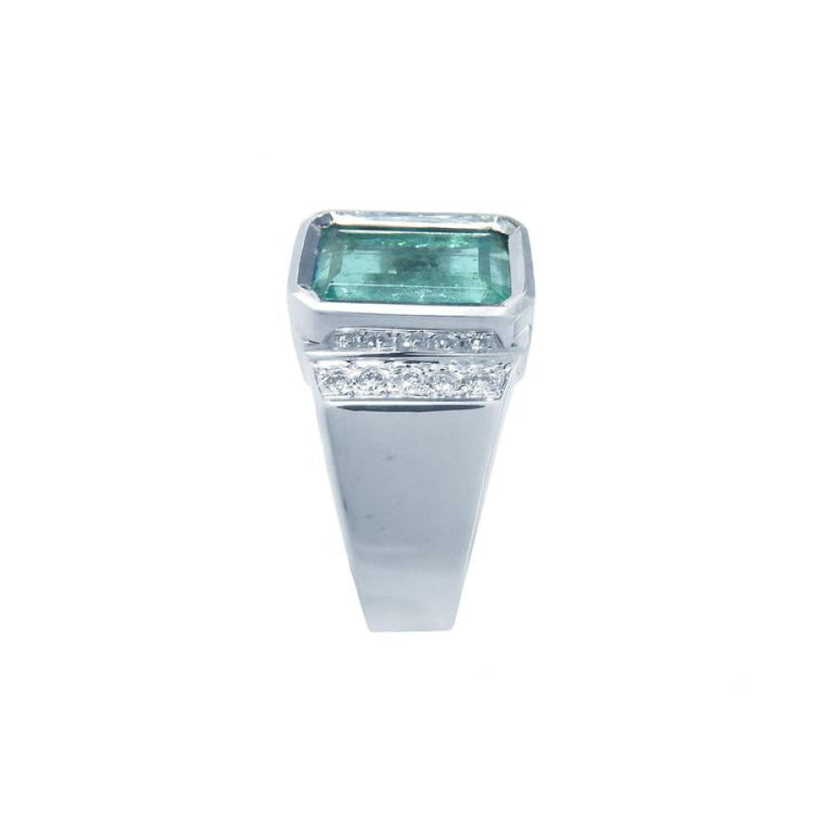 Men's 18K white gold ring with a bezel-set emerald-cut bluish-green emerald and diamond accents.