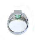 The underside view of a white gold men's emerald ring.