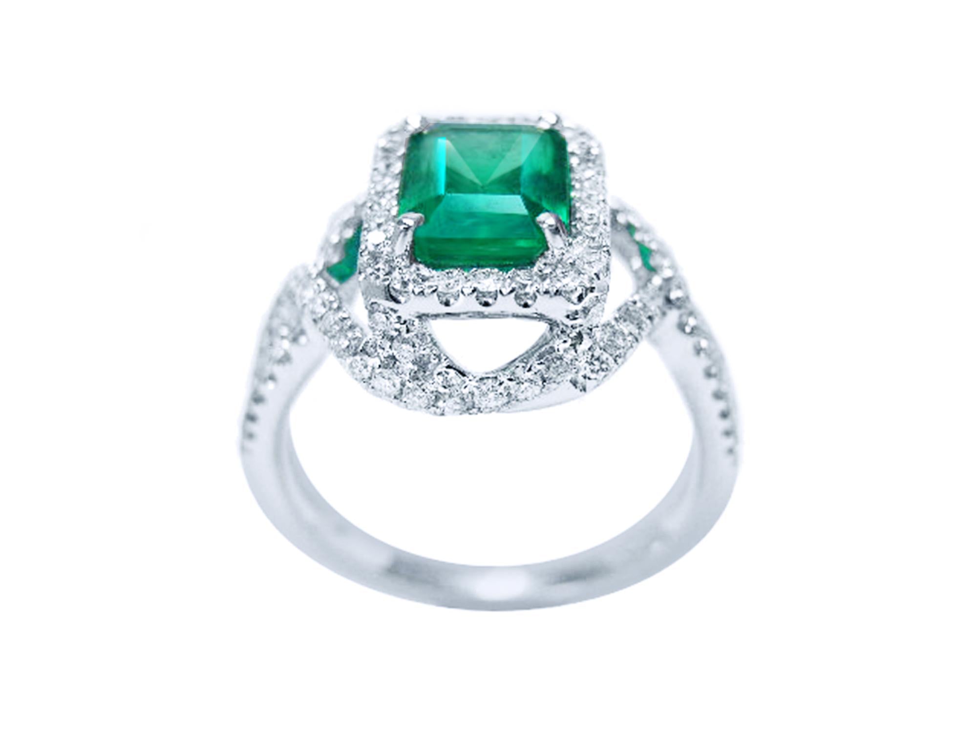 This 18k white gold natural emerald ring displays the top and gallery lateral side.
