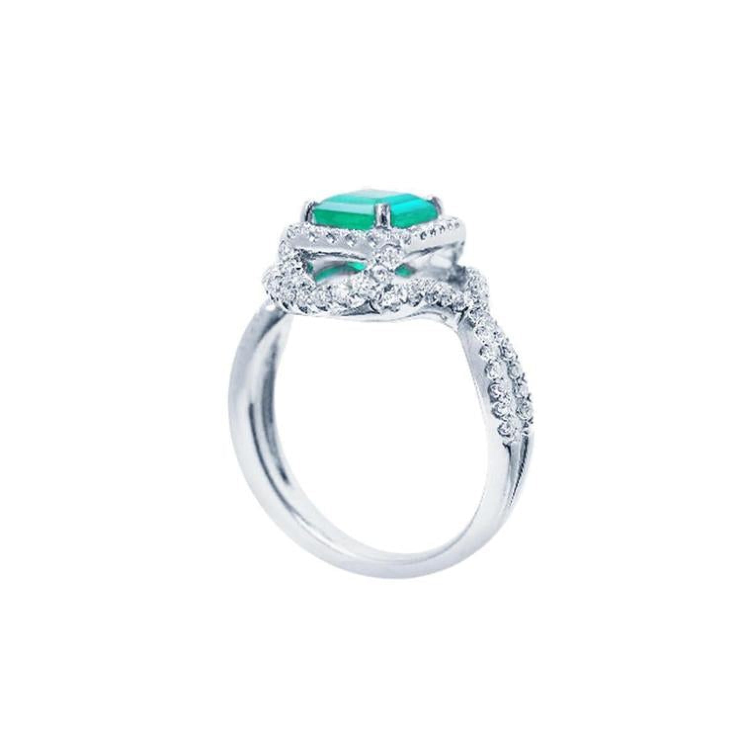 18K white gold ring with a vibrant emerald-cut emerald and sparkling halo diamonds.