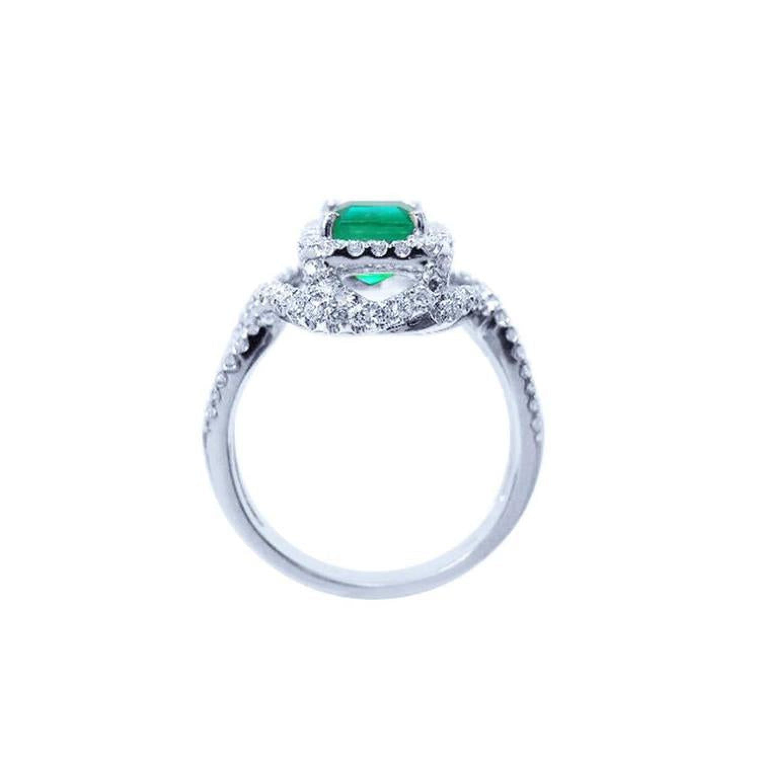 Emerald-cut natural emerald ring with halo diamonds on an 18K white gold band.