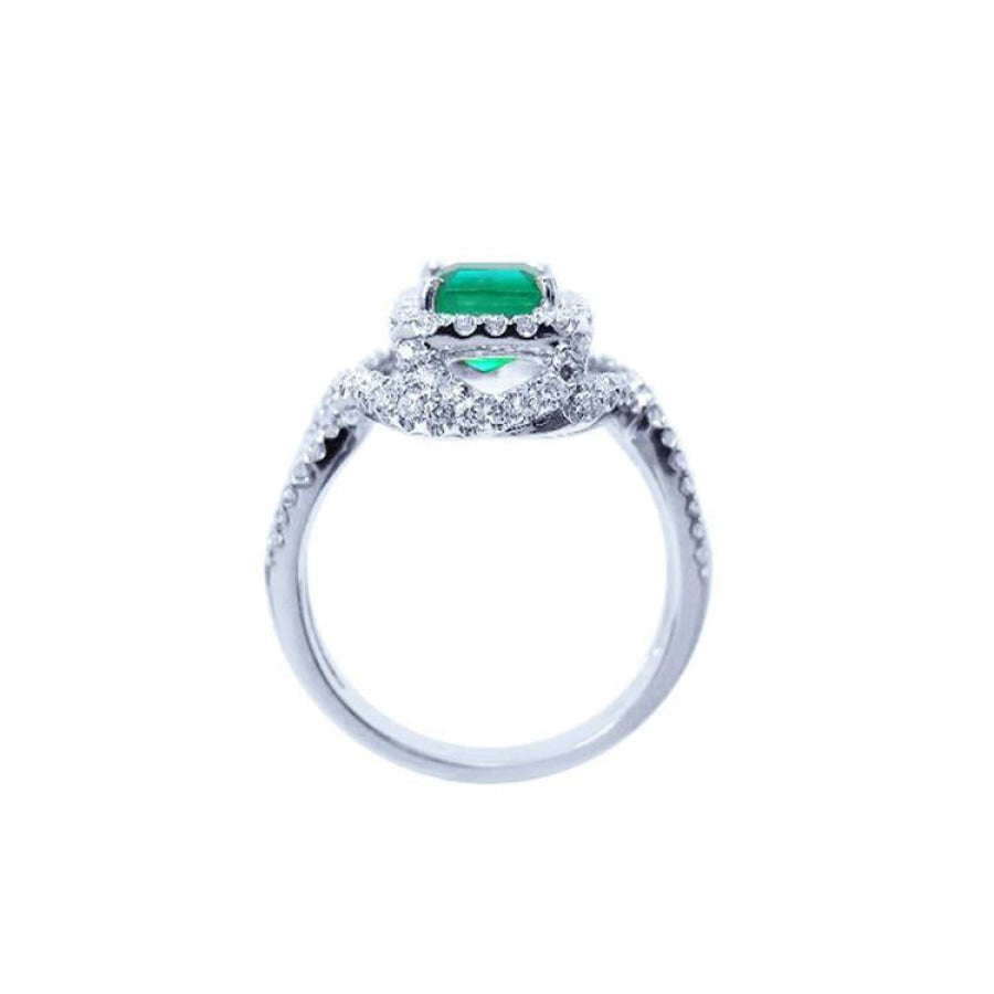 Emerald-cut natural emerald ring with halo diamonds on an 18K white gold band.