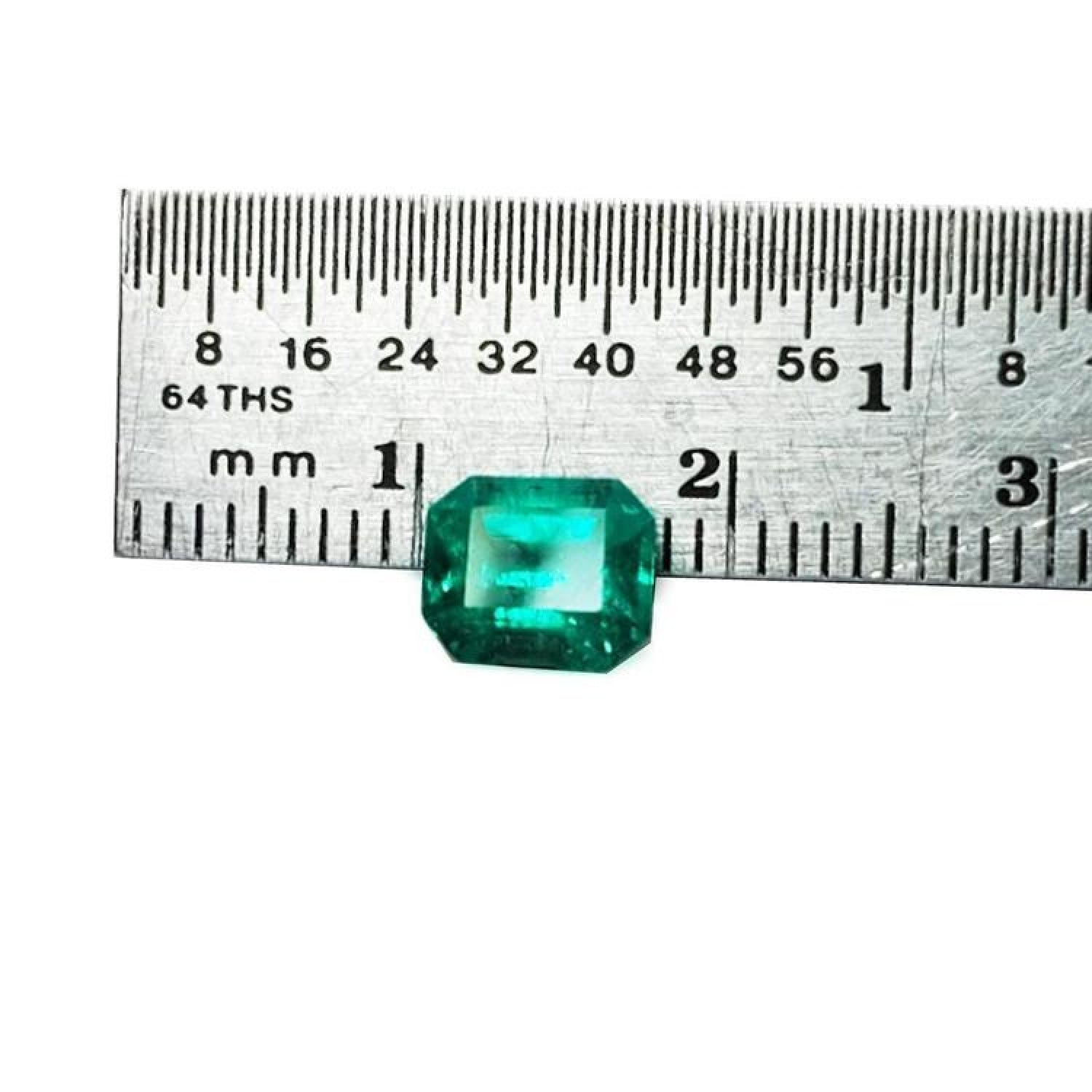 Emerald-cut 1.41 carat natural loose Colombian emerald, medium deep bluish green, shown with a ruler.