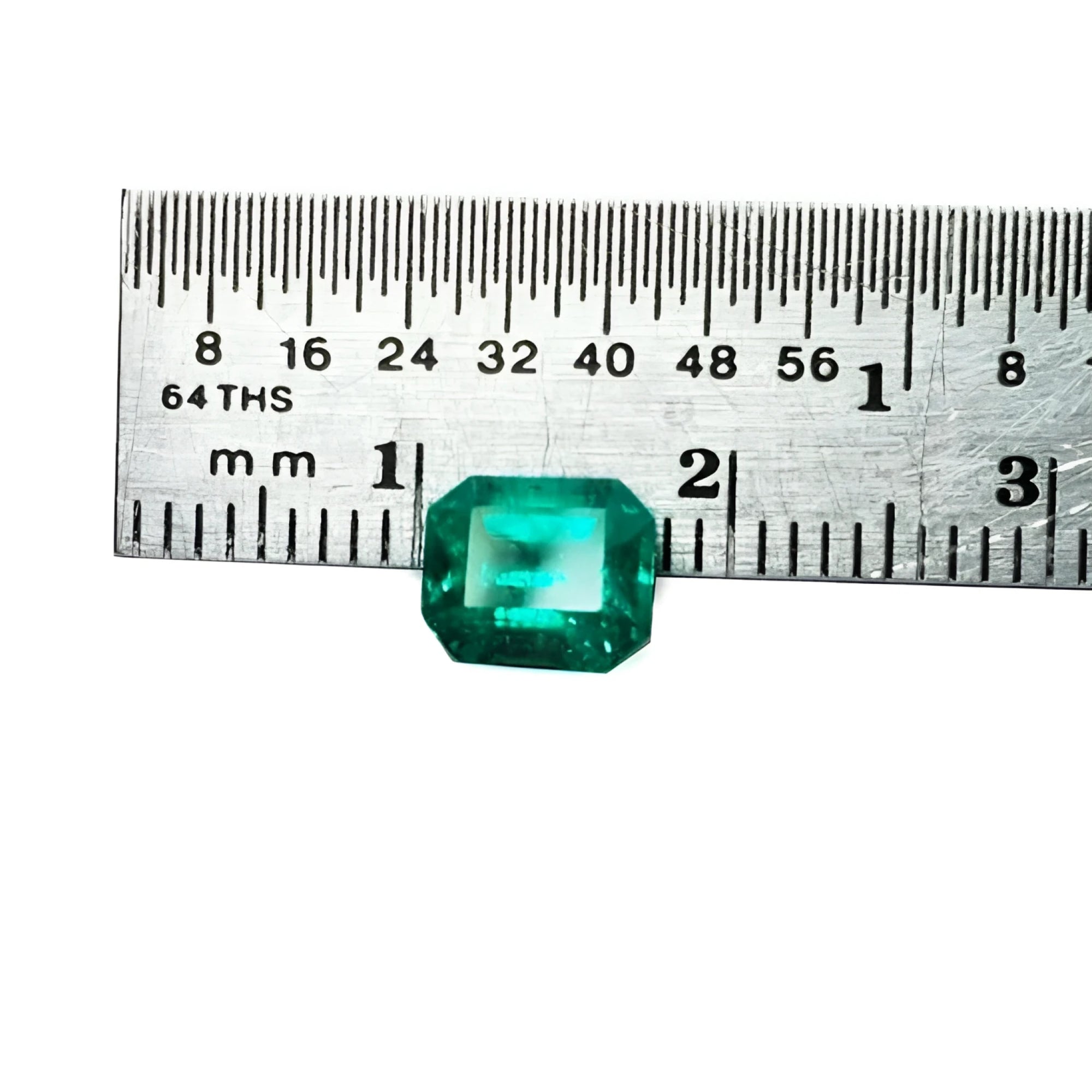 Emerald-cut 1.41 carat natural loose Colombian emerald, medium deep bluish green, shown with a ruler.