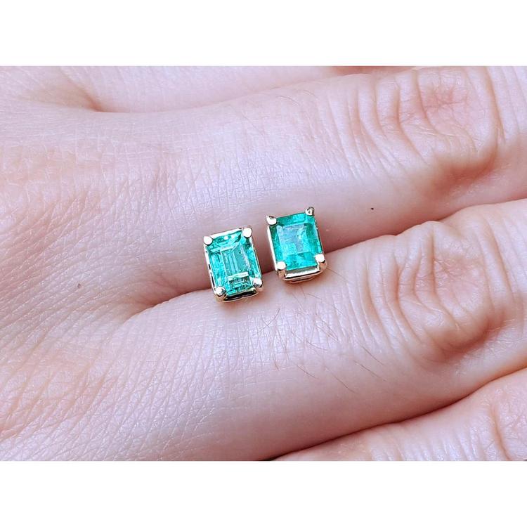 Emerald-cut natural emerald stud earrings, 1.29 ct, set in 14K yellow gold.