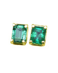 Pair of emerald-cut stud emerald earrings with yellow gold frames, front side top vie.