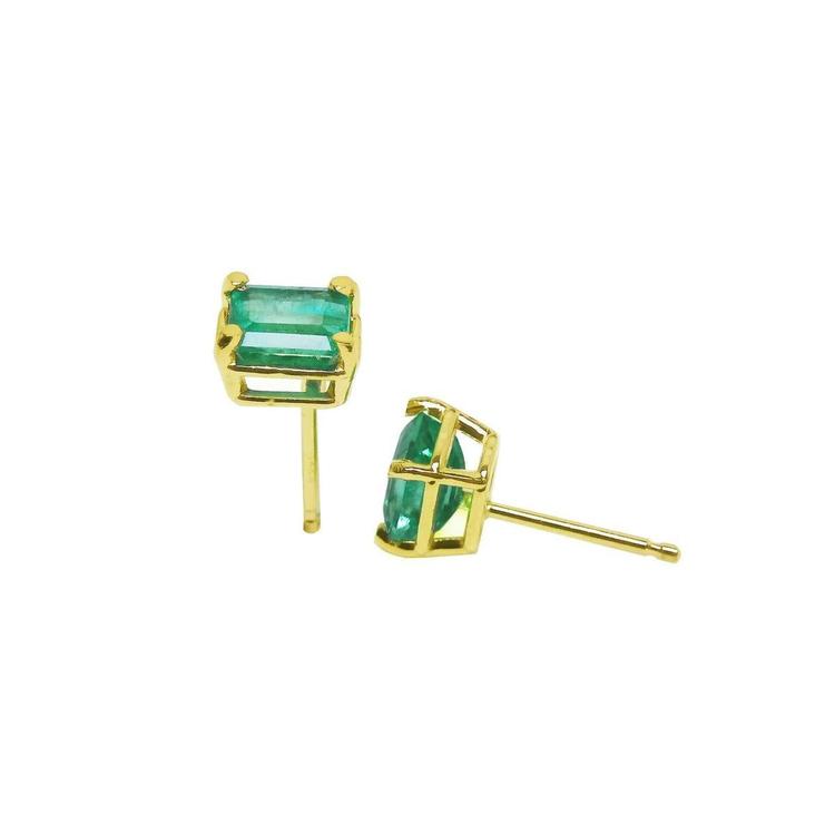 Emerald-cut natural emerald stud earrings, 1.29 ct, set in 14K yellow gold basket settings.